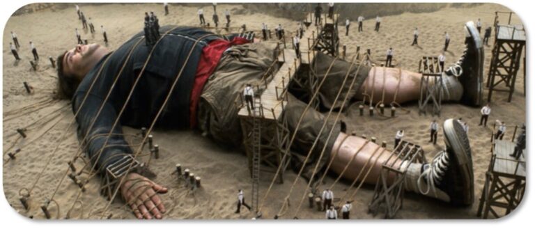 Giant being tied won by lots of small people depicting our restrictive mindset